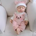 Realistic 12 inch soft silicone reborn doll in pink bear outfit sitting on a sofa - Pink Bear Style / 30 cm