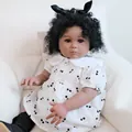 24-inch reborn girl doll with curly hair and cherry print dress on cozy sofa - 60cm Cloth Body Style / Dark Skin Cherry Print Style