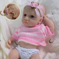 Close-up of the realistic belly button detail on a lifelike reborn baby doll - Pink White Striped Style