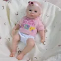 Realistic 12-inch reborn baby doll in pink knit sweater with special delivery embroidery - Pink Embroidered Outfit Style / 30 cm