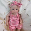 Lifelike 12-inch reborn baby doll in red plaid jumpsuit with bow on soft textile - Red Plaid Style / 32cm