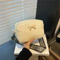 Creamy white small square crossbody bag with golden bow and patterned wide shoulder strap - Off White