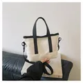 Detail of minimalist cream tote bag with black trim and adjustable shoulder strap - Off White