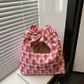 Pink and white checkered tote bag with red floral prints and decorative bow handles - Pink