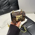 Mini leopard print crossbody chain bag with metallic gold buckle and textured leather finish - Leopard Brown