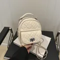 Quilted off-white mini backpack with chain strap and metallic turn-lock closure - White