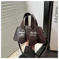 Detail of dark brown vintage punk bag with silver buckles and metal eyelets texture - Brown