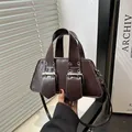 Dark brown retro punk handbag with metallic studs and glossy finish in a modern style - Brown