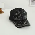 Detail of colorful rhinestones spelling Love on a black baseball cap surface - One Size / Black