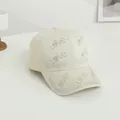Detailed side view of cream cotton baseball cap with Love pattern in colorful rhinestones - One Size / Beige