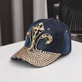 Detailed view of dark blue denim baseball cap featuring amber gems and sparkling rhinestones - Adjustable / Dark Blue Distressed
