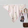 Elegant floral silk scarf in pale pink hanging with stylish fashion accessories - 70x70 / Pink Vine Floral
