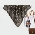 Coffee brown paisley silk scarf paired with a brown leather handbag and wooden accessories - Light Brown