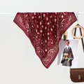Detailed view of burgundy paisley silk scarf with elegant drape and fine printed edges - Burgundy