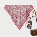 Classic paisley silk scarf in red and beige hanging with luxury fashion accessories - Red Paisley