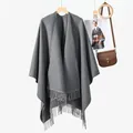 Poncho scialle in maglia grigio scuro a tinta unita con lunghe nappe su sfondo bianco - Grigio