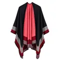 Close-up showing the soft knit texture and striped geometric patterns of this poncho - Single Stripe / Black