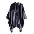 Detail of grey and black geometric wave pattern on a thick knitted open-front shawl - Black
