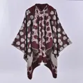 Detail of burgundy knitted shawl showing thick jacquard fabric and white stitched edges - Hooded Tulip Wine Red