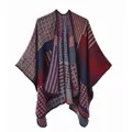 Close-up of thick knitted poncho featuring geometric patterns and red-blue color blocking - Navy Red Geometric Stripe