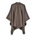 Macro detail of the high-density knit fabric and geometric pattern on this autumn shawl - Coffee