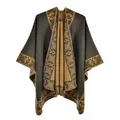 Detail of green ethnic poncho with thick cashmere-like texture and geometric knit patterns - Green