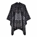 Close-up detail of the thick jacquard knitting and geometric pattern on a gray poncho - Black