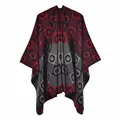 Detail of red and black geometric pattern on soft knit poncho with tassel textures - Black Red