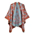 Close-up of thick knitted leopard print shawl with tricolor pattern and overlock stitching - Orange Leopard