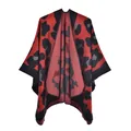 Detailed view of red leopard print knit shawl with thick fabric and black hemmed edges - Black Red Leopard