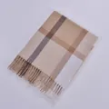 Close-up of beige and brown checkered scarf with tassel detail for autumn and winter fashion - Khaki Beige