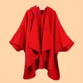 Detailed view of the red knitted poncho featuring a hood and thick textured fabric - Solid Hooded Large Red