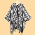 Detail view of stylish houndstooth shawl with long decorative fringe and knit texture - Hooded Houndstooth Black White