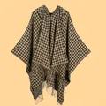 Detail of classic houndstooth knit shawl featuring long fringe tassels and a soft texture - Hooded Houndstooth Black Camel
