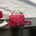 Fashionable red litchi texture crossbody bag with gold hardware and envelope flap - Red