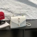 Elegant white litchi pattern crossbody bag with golden hardware and top handle - White