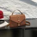Minimalist brown lychee texture leather handbag with gold metal buckle and shoulder strap - Brown