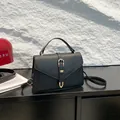Classic black litchi pattern leather handbag with gold buckle and elegant top handle - Black