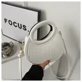 Detail showing white pleated texture and circular handle of the half-moon bag - White
