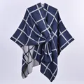 Detail showing blue and white plaid knit shawl texture and refined stitching of the poncho - Navy Plaid