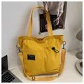 Versatile bright yellow canvas tote bag with functional pockets and adjustable strap - Yellow