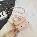 Mini borsa rosa a pois con fiocco in metallo argentato e tracolla coordinata - Rosa