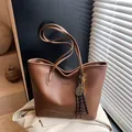 Vintage caramel brown tote bag with fashion embossing and tassel charm details - Brown with Pendant