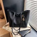 Large black pebbled leather tote bag with fashion embossing and tennis racket charm - Black With Pendant