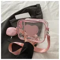Detail of pink transparent PVC crossbody bag featuring heart patch and round coin purse - Pink