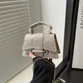 Mini silver-grey chain crossbody bag with metallic texture and circular buckle - Gray