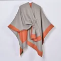 Detail showing soft gray and orange knit texture with knotted design on split shawl - Grey and Orange