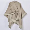 Close-up of khaki cashmere-feel shawl featuring contrast trim and front knot design - Khaki and White