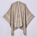 Close-up of cashmere-like poncho shawl with horse jacquard pattern and fringe detail - Border War Macaroni / 130x150cm