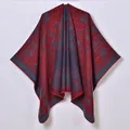 Detailed close-up of ethnic jacquard pattern with elephants on warm knitted poncho shawl - 130x150 / Red